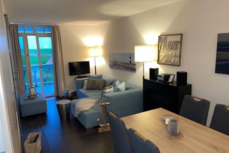 Resort Deichgraf Resort Deichgraf 27-12 Wremen - Wohn-/Essbereich mit Sitzgelegenheit