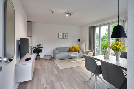 Lüttjeod Apartmentvilla Lüttjeod Apartmentvilla 03 Langeoog - Wohn-Essbereich mit Flatscreen TV und Sitzgelegenheit