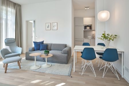 Lüttjeod Apartmentvilla Lüttjeod Apartmentvilla 06 Langeoog - Wohn-Essbereich mit Couch, Sessel und Esstisch
