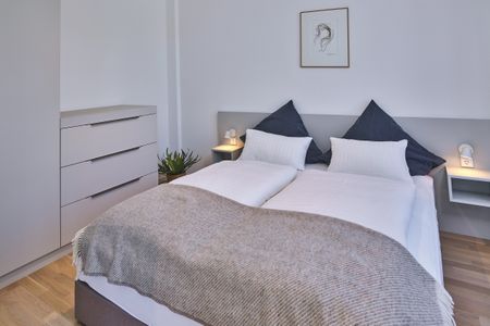 Lüttjeod Apartmentvilla Lüttjeod Apartmentvilla 01 Langeoog - Schlafzimmer mit Doppelbett und Kleiderschrank