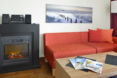 Resort Deichgraf Resort Deichgraf 31-03 Wremen - Wohn-Essbereich mit Couch