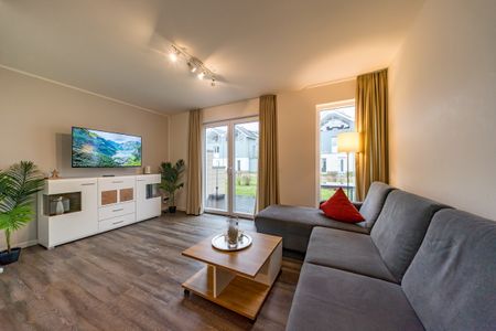 NordseeResort Friesland Ferienhäuser NordseeResort Friesland 11 Schillig - Wohn-Essbereich mit Couch