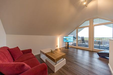 NordseeResort Friesland Ferienhäuser NordseeResort Friesland 11 Schillig - Wohn-Essbereich mit Couch