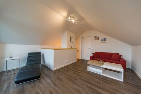 NordseeResort Friesland Ferienhäuser NordseeResort Friesland 11 Schillig - Wohn-Essbereich mit Couch