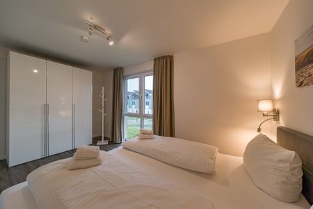 NordseeResort Friesland Ferienhäuser NordseeResort Friesland 11 Schillig - Schlafzimmer mit Doppelbett