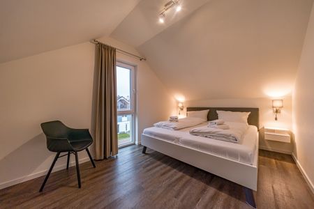 NordseeResort Friesland Ferienhäuser NordseeResort Friesland 11 Schillig - Schlafzimmer mit Doppelbett