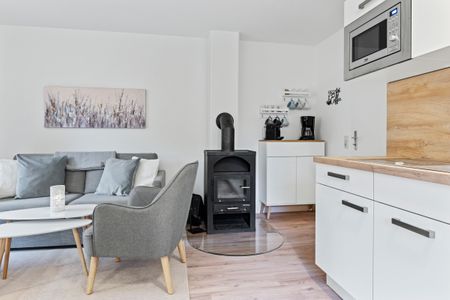 Urlauberdorf Urlauberdorf 42a Boltenhagen - Wohn-Essbereich mit Couch Kaminofen
