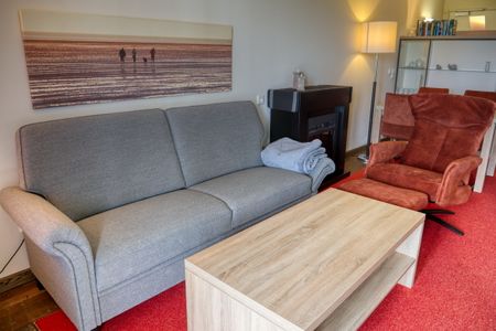 Resort Deichgraf Resort Deichgraf 31-12 Wremen - Wohn-Essbereich mit Couch