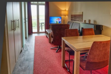 Resort Deichgraf Resort Deichgraf 31-12 Wremen - Wohn-Essbereich mit Couch