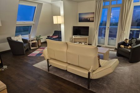 Resort Deichgraf Resort Deichgraf 31-21 Wremen - Wohn-Essbereich mit Couch