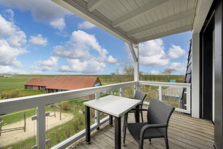 Resort Deichgraf Resort Deichgraf 27-13 Wremen - Überdachter Balkon mit Sitzgelegenheit