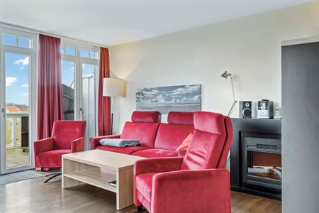 Resort Deichgraf Resort Deichgraf 27-20 Wremen - Wohnzimmer mit Couch, Couchtisch und Sessel