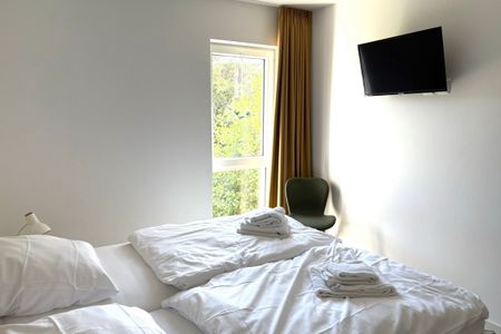 NordseeResort Friesland Ferienhäuser Nordseeresort Friesland 50-1-s Schillig - Schlafzimmer mit Doppelbett und Flatscreen TV - gbmv0-01 - Großenbrode