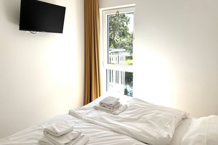 NordseeResort Friesland Ferienhäuser Nordseeresort Friesland 50-1-s Schillig - 2. Schlafzimmer mit Doppelbett