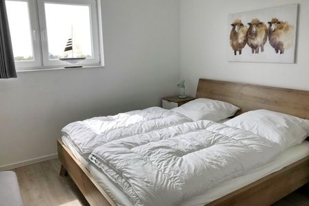 NordseeResort Friesland Ferienhäuser NordseeResort Friesland 48-6-n Schillig - Schlafzimmer mit Doppelbett
