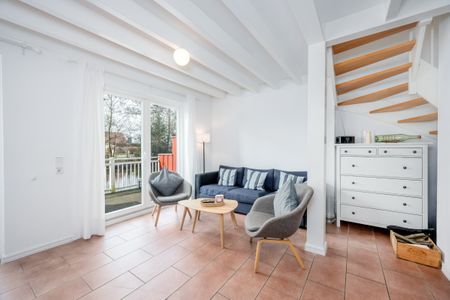 NordseeResort Friesland Ferienhäuser NordseeResort Friesland 30 Schillig - Wohn-Essbereich mit Couch