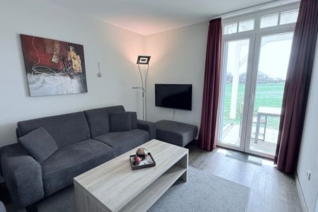 Resort Deichgraf Resort Deichgraf 31-04 Wremen - Wohn-Essbereich mit Couch