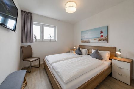 NordseeResort Friesland NordseeResort Friesland 48-6-n Schillig - Schlafzimmer mit Doppelbett im sinf48-6-N, Nordsee-Resort Friesland, Mellumweg 1 in Schillig
