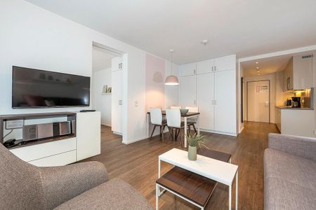 Apartmentvilla Anna See Apartmentvilla Anna See 1-08 Langeoog - Wohn-Essbereich mit Flatscreen-TV