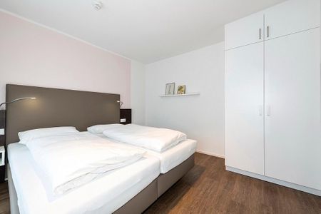 Apartmentvilla Anna See Apartmentvilla Anna See 1-08 Langeoog - Schlafzimmer mit Doppelbett und Kleiderschrank