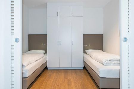 Apartmentvilla Anna See Apartmentvilla Anna See 2-01 Langeoog - Schlafzimmer mit zwei Einzelbetten und Kleiderschrank