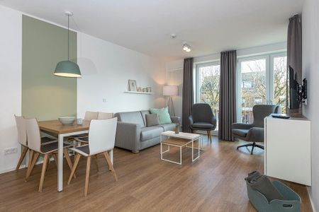 Apartmentvilla Anna See Apartmentvilla Anna See 2-02 Langeoog - Wohn-Essbereich mit Couch und Sessel