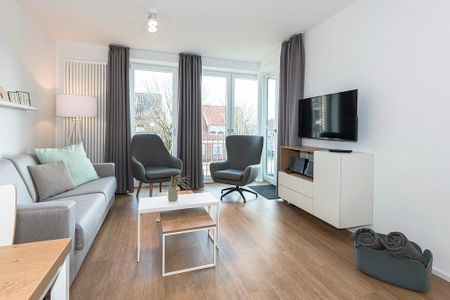 Apartmentvilla Anna See Apartmentvilla Anna See 2-02 Langeoog - Wohn-Essbereich mit Couch und TV