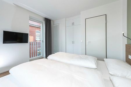 Apartmentvilla Anna See Apartmentvilla Anna See 2-02 Langeoog - Schlafzimmer mit Doppelbett und Kleiderschrank