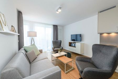 Apartmentvilla Anna See Apartmentvilla Anna See 1-11 Langeoog - Wohnbereich mit Flatscreen-TV