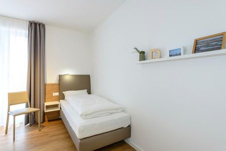 Deichhäuser Anna Küste Deichhäuser Anna Küste 1-14 Bensersiel - Schlafzimmer mit zwei Einzelbetten und Stuhl