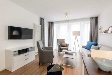 Deichhäuser Anna Küste Deichhäuser Anna Küste 1-24 Bensersiel - Wohn/Essbereich mit Esstisch, Couch, Sesseln und TV