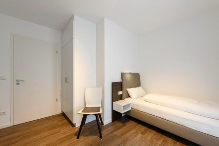 Deichhäuser Anna Küste Deichhäuser Anna Küste 1-24 Bensersiel - Schlafzimmer mit Einzelbetten, Stuhl und Kleiderschrank