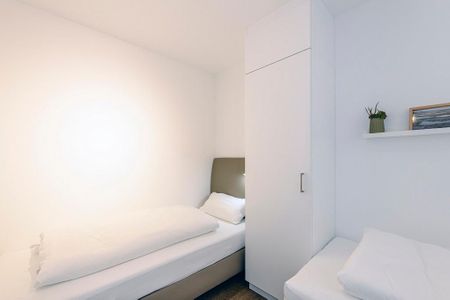 Deichhäuser Anna Küste Deichhäuser Anna Küste 1-31 Bensersiel - Schlafzimmer mit zwei Einzelbetten und Kleiderschrank