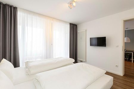 Deichhäuser Anna Küste Deichhäuser Anna Küste 1-34 Bensersiel - Schlafzimmer mit Doppelbett und TV