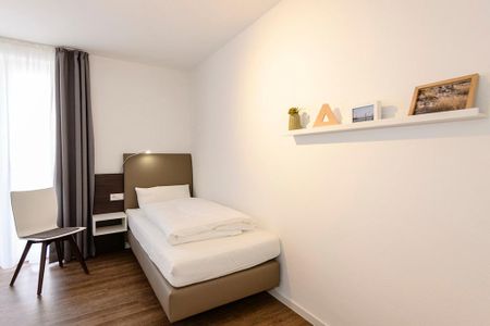 Deichhäuser Anna Küste Deichhäuser Anna Küste 1-34 Bensersiel - Schlafzimmer mit zwei Einzelbetten und Stuhl