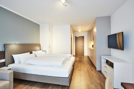 Deichhäuser Anna Küste Deichhäuser Anna Küste 2-32 Bensersiel - Wohn/Essbereich mit Doppelbett, TV, Küchenzeile und Kleiderschrank