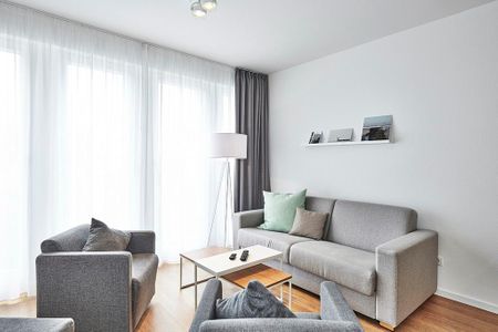 Deichhäuser Anna Küste Deichhäuser Anna Küste 3-14 Bensersiel - Wohnbereich mit Couch und Sesseln