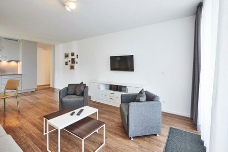 Deichhäuser Anna Küste Deichhäuser Anna Küste 3-20 Bensersiel - Wohnbereich mit Sesseln und Flatscreen-TV