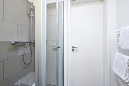 Deichhäuser Anna Küste Deichhäuser Anna Küste 3-33 Bensersiel - Badezimmer mit Dusche, WC, Waschtisch und Spiegel