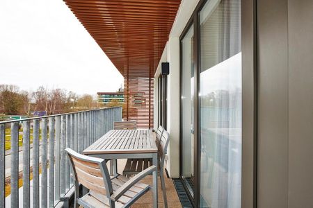 Deichhäuser Anna Küste Deichhäuser Anna Küste 3-33 Bensersiel - Überdachter Balkon mit Sitzgelegenheit