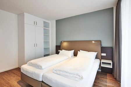 Deichhäuser Anna Küste Deichhäuser Anna Küste 3-34 Bensersiel - Schlafzimmer mit Doppelbett und Kleiderschrank