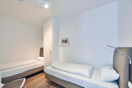 Deichhäuser Anna Küste Deichhäuser Anna Küste 4-11 Bensersiel - Schlafzimmer mit zwei Einzelbetten und Kleiderschrank