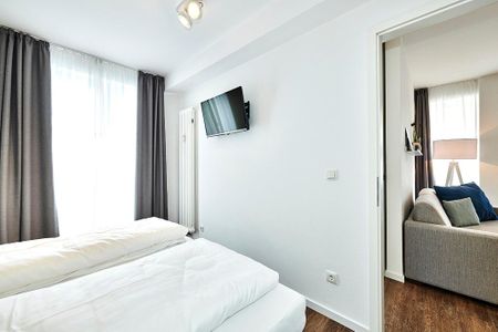 Deichhäuser Anna Küste Deichhäuser Anna Küste 4-13 Bensersiel - Schlafzimmer mit Doppelbett, Kleiderschrank und Flatscreen TV