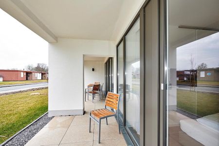Deichhäuser Anna Küste Deichhäuser Anna Küste 4-13 Bensersiel - Überdachte Terrasse mit Sitzgelegenheit