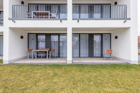 Deichhäuser Anna Küste Deichhäuser Anna Küste 4-13 Bensersiel - Überdachte Terrasse mit Sitzgelegenheit und Grünfläche