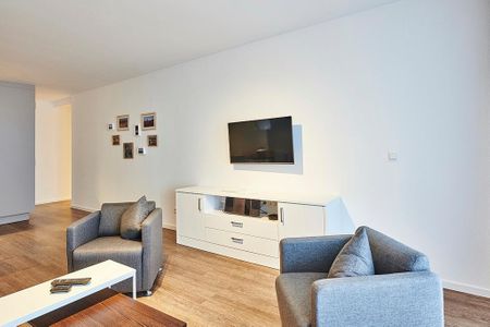 Deichhäuser Anna Küste Deichhäuser Anna Küste 4-20 Bensersiel - Wohnbereich mit Flatscreen-TV