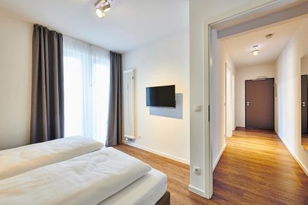 Deichhäuser Anna Küste Deichhäuser Anna Küste 4-20 Bensersiel - Schlafzimmer mit Doppelbett und Flatscreen TV