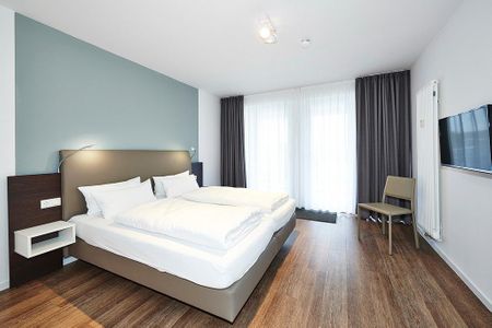 Deichhäuser Anna Küste Deichhäuser Anna Küste 4-21 Bensersiel - Schlafzimmer mit Doppelbett und Zugang zum Balkon