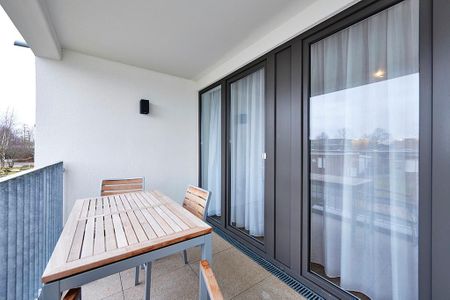 Deichhäuser Anna Küste Deichhäuser Anna Küste 4-21 Bensersiel - Überdachte Terrasse mit Sitzgelegenheit