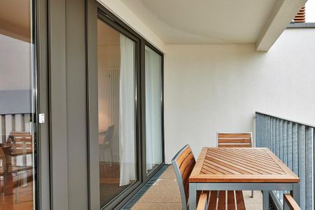 Deichhäuser Anna Küste Deichhäuser Anna Küste 4-22 Bensersiel - Überdachter Balkon mit Sitzgelegenheit